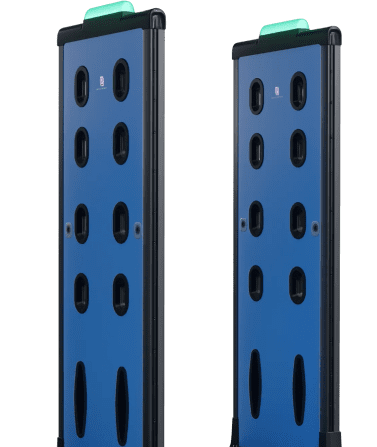 Two blue metal gates with green lights, part of an advanced AI weapons detection system.