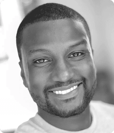 Black and white photo of Terrence Tyson, a smiling man known for capturing authentic moments in marketing visuals.