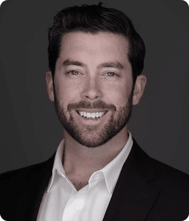 A man with a beard wearing a white shirt, representing Eric Hill, Key Account Manager with over 10 years of experience.