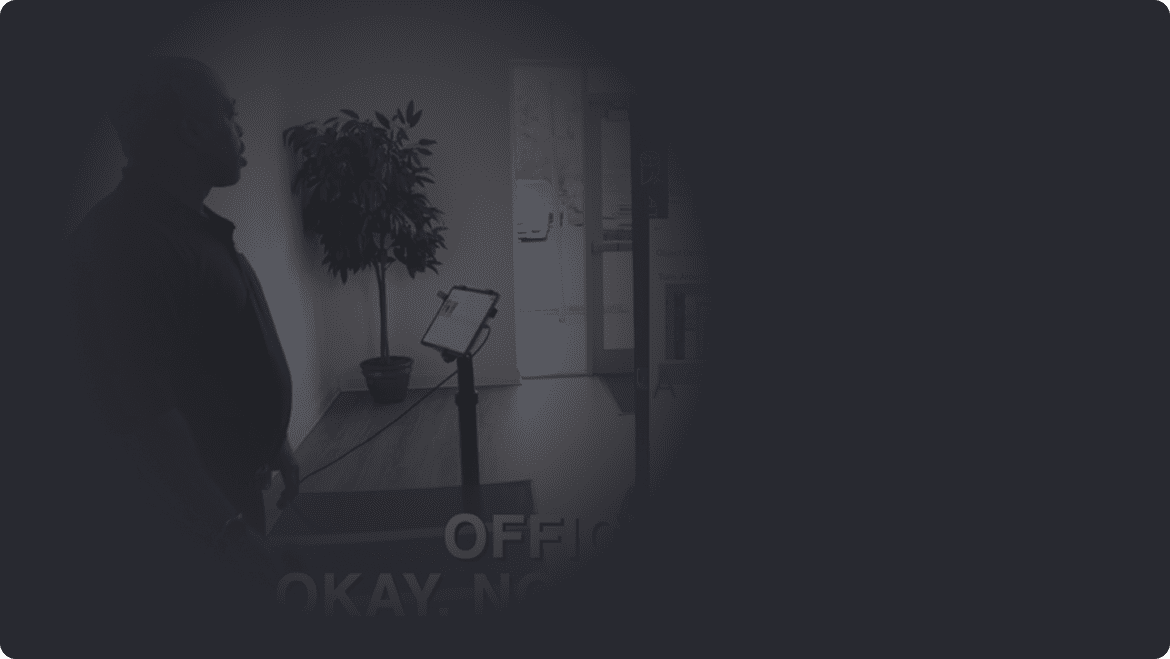 A man stands before a large sign reading "Okay, no more meetings," emphasizing a break from discussions.