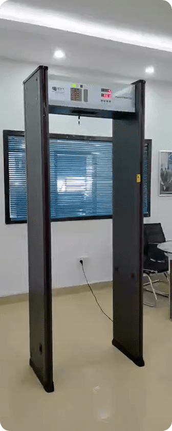 A metal detector placed in a room featuring a desk, showcasing a hardware-agnostic weapons detection platform.