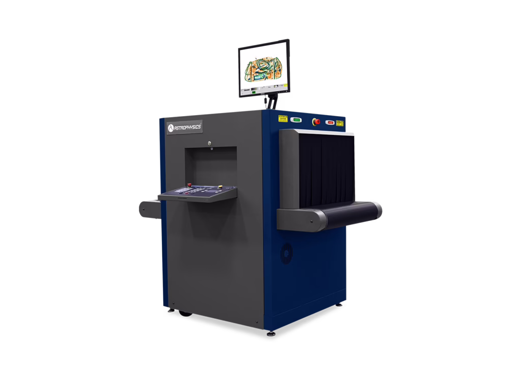 Astrophysics Inc XIS-6040 X-ray inspection system with blue and gray body, conveyor tunnel, control panel, and monitor displaying scanned baggage image